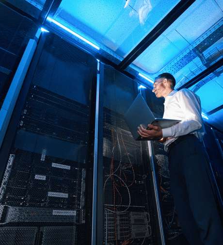 Technician monitoring industrial server racks in a data center