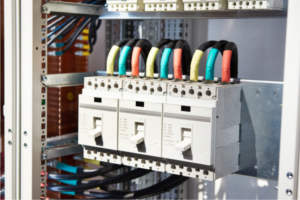 industrial circuit breakers connected in a panel, demonstrating electrical setup