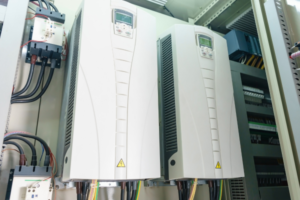 Row of industrial inverters with orange display panels, modern design.