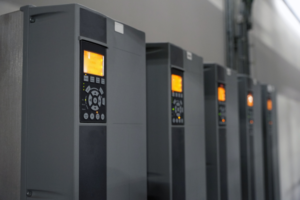 Row of industrial drives with orange display panels, modern design.