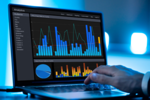 Person analyzing data on a laptop with graphs and charts.